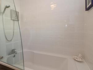 a bathroom with a shower and a bath tub at Summerhill in Hereford +22 photos