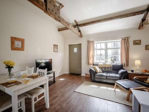 a living room with a table and a couch at 1 Bed in Hexham oc-82473 in Hexham