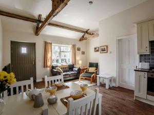 a kitchen and living room with a table and chairs at 1 Bed in Hexham oc-82473 in Hexham