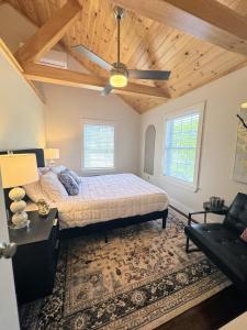 a bedroom with a bed and a ceiling fan at 3 Bedroom Happy Cottage 15 in Edgecomb