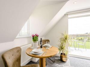 a dining room with a table and chairs and a window at 1 Bed in Weymouth oc-82098 in Osmington +7 photos