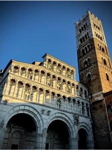 a large building with a clock tower in the background at Authentic Tuscan Studio in Lucca with Private Patio in Lucca +3 photos