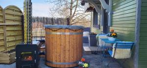 a wood stove and a grill on a patio at le chalet vert & bain nordique privatif Skadi tps de chauffe 1h30 in Frambouhans