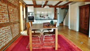 a kitchen with a wooden table and chairs at Design trifft Denkmal in Wangen im Allgäu