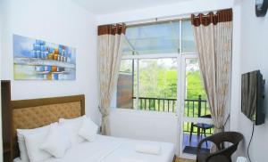 a bedroom with a bed and a large window at Hill Cool Hotel & Restaurant in Hatton