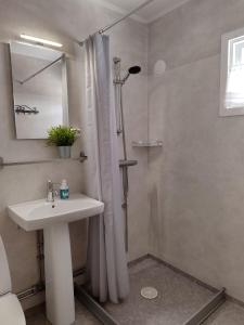 a bathroom with a sink and a shower with a shower curtain at Näckros in Filipstad +45 photos