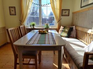 a living room with a table and a couch at Näckros in Filipstad