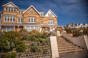 a large brick house with stairs in front of it at Oceanview in Woolacombe