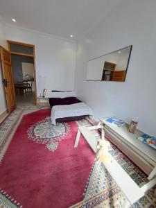 a living room with a red rug and a mirror at Central Tangier , 3xBedroom , Apartment, Historic Medina, Margarita in Tangier +18 photos