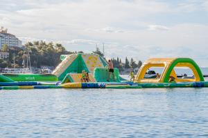 a group of inflatables in the water at MASLINICA Oliva Camping Pitches in Rabac +152 photos