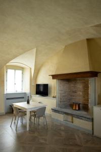 a kitchen with a table and a fireplace at Residence Palmento in Franciacorta in Corte Franca