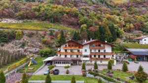 an aerial view of a large house in a mountain at Residence Fallrohrhof in Naturno
