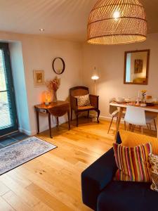 a living room with a couch and a table at Crymlyn barn in Llanwrda
