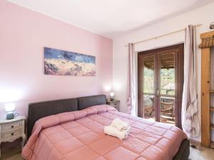 a bedroom with a pink bed and a window at Apartment Casa Domenico n- 1 by Interhome in Montefiascone