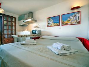 a bedroom with a large bed with towels on it at Casa Gallo in Santa Marinella +153 photos