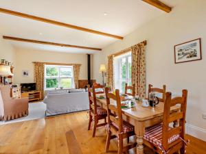 a living room with a table and chairs and a couch at 2 Bed in Dulverton oc-threb in East Anstey