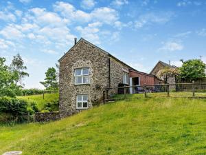 a stone house on top of a grassy hill at 2 Bed in Dulverton oc-threb in East Anstey