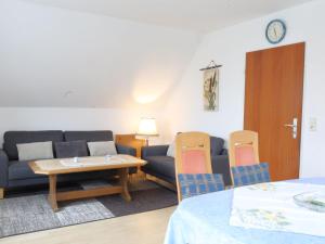 a living room with a couch and chairs and a table at Apartment Schonerweg by Interhome in Norddeich
