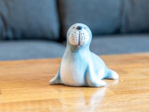 a figurine of a seal sitting on a table at Holiday Home Gila by Interhome in Dornumersiel