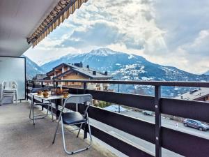 a balcony with a table and chairs and a view of a mountain at Apartment App- 20A Ramuge by Interhome in Veysonnaz
