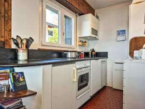 a kitchen with white cabinets and a stove top oven at Apartment App- 20A Ramuge by Interhome in Veysonnaz