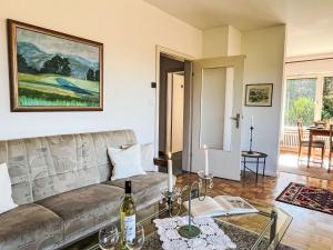 a living room with a couch and a table at Holiday Home Sonnenbühl by Interhome in Dittishausen