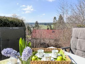 a table with a tray of food and flowers on it at Holiday Home Sonnenbühl by Interhome in Dittishausen