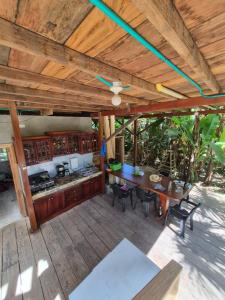 an outdoor kitchen with a table and chairs on a deck at Cabaña LA IGUANA in Capurganá