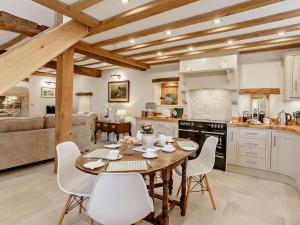 a kitchen with a wooden table and chairs in a room at 2 Bed in Skipton oc-91296 in Bramley