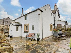 a white house with a patio and a table and chairs at 2 Bed in Skipton oc-91296 in Bramley