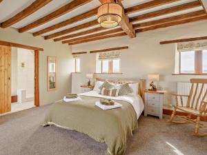 a bedroom with a large bed and a chair at 3 Bed in Richmond oc-91578 in Caldwell