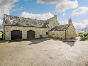 an old stone building with two large garage doors at 3 Bed in Richmond oc-91578 in Caldwell