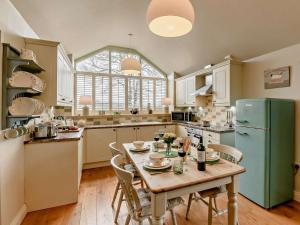 a kitchen with a table and a green refrigerator at 2 Bed in York oc-91540 in Brandsby