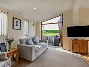 a living room with a couch and a flat screen tv at 2 Bed in Sowerby Bridge oc-90887 in Sowerby Bridge