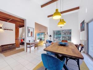 a dining room and living room with a wooden table at Holiday Home Bernadon by Interhome in Labenne