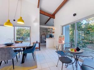 a kitchen and dining room with a table and chairs at Holiday Home Bernadon by Interhome in Labenne