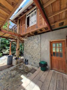 a porch of a house with a wooden door at Cabaña LA IGUANA in Capurganá