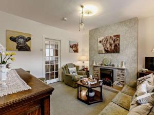 a living room with a couch and a fireplace at 2 Bed in Consett oc-91440 in Hunstanworth