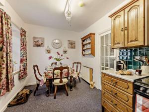 a kitchen with a table and chairs in a room at 2 Bed in Consett oc-91440 in Hunstanworth
