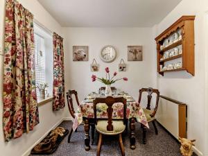 a dining room with a table with flowers on it at 2 Bed in Consett oc-91440 in Hunstanworth +11 photos