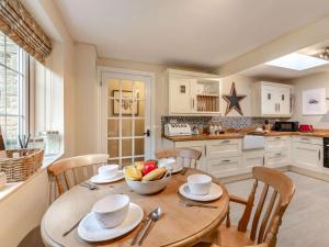 a kitchen with a table with a bowl of fruit on it at 2 Bed in Consett oc-90576 in Whittonstall