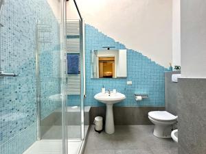 a bathroom with a sink and a glass shower at Galli Tassi Suite in Lucca +22 photos