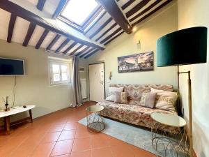 a living room with a couch and a window at Galli Tassi Suite in Lucca