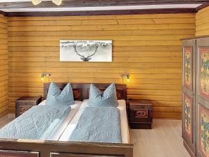 two beds in a room with wooden walls at Apartment Franzi 2 by Interhome in Arrach