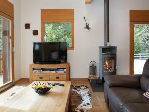 a living room with a couch and a fireplace at Chalet Banksia by Interhome in Ovronnaz +33 photos