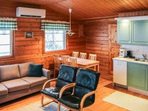 a living room with a couch and a table at Holiday Home Ruskatupa by Interhome in Ruka