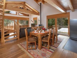 a kitchen and dining room with a wooden table and chairs at Chalet Banksia by Interhome in Ovronnaz