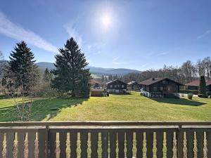a view of a yard with houses and a fence at Apartment Franzi 2 by Interhome in Arrach