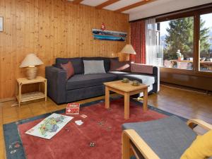 a living room with a couch and a table at Apartment Centaure B RI 1 by Interhome in Ovronnaz