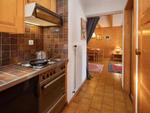 a kitchen with a stove and a counter top at Apartment Centaure B RI 1 by Interhome in Ovronnaz